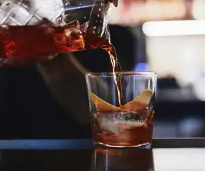 bartender pouring a cocktail